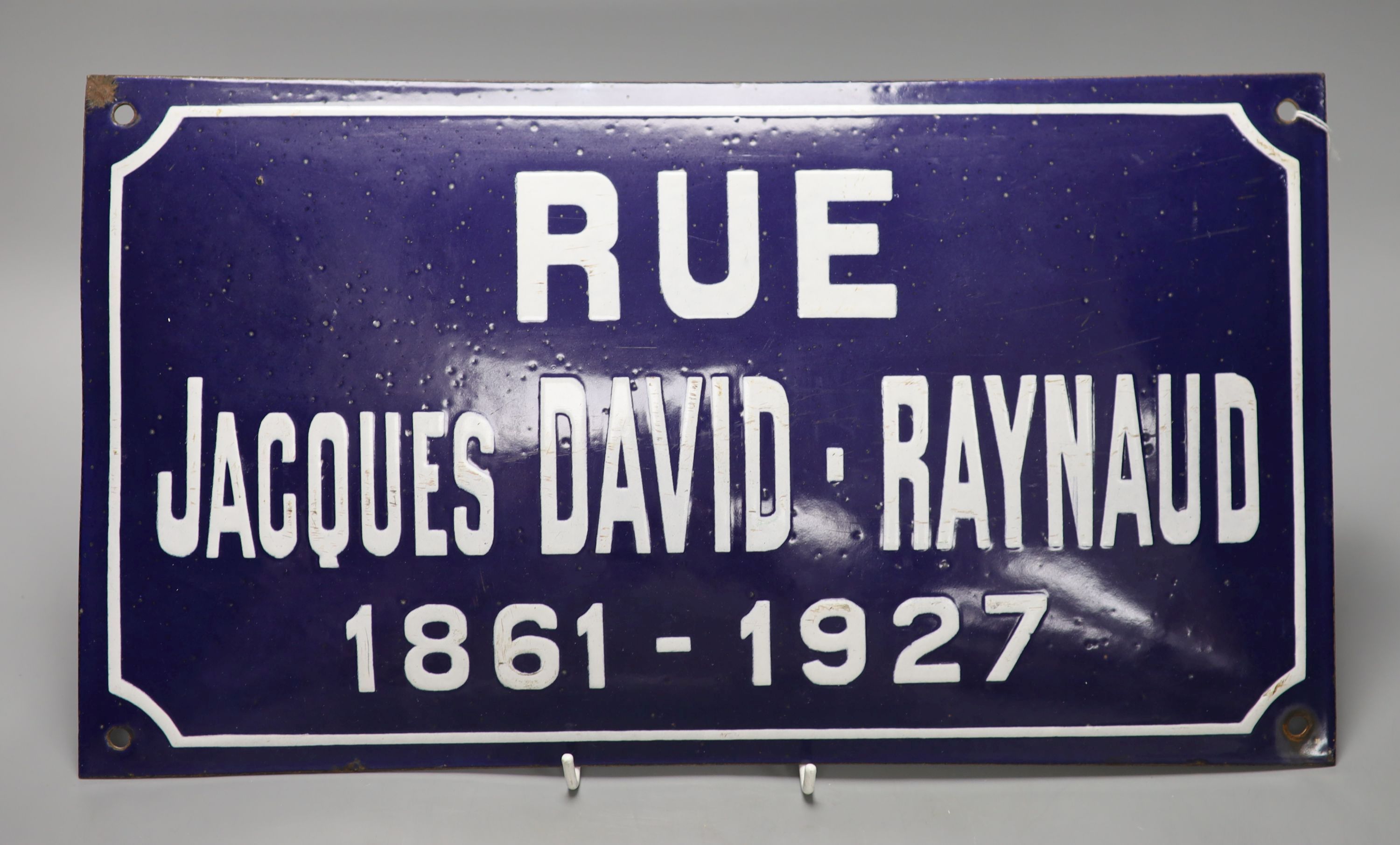 A French blue enamelled street sign 'RUE JACQUES DAVID-RAYNAUD 1861-1927', 25 x 45cm